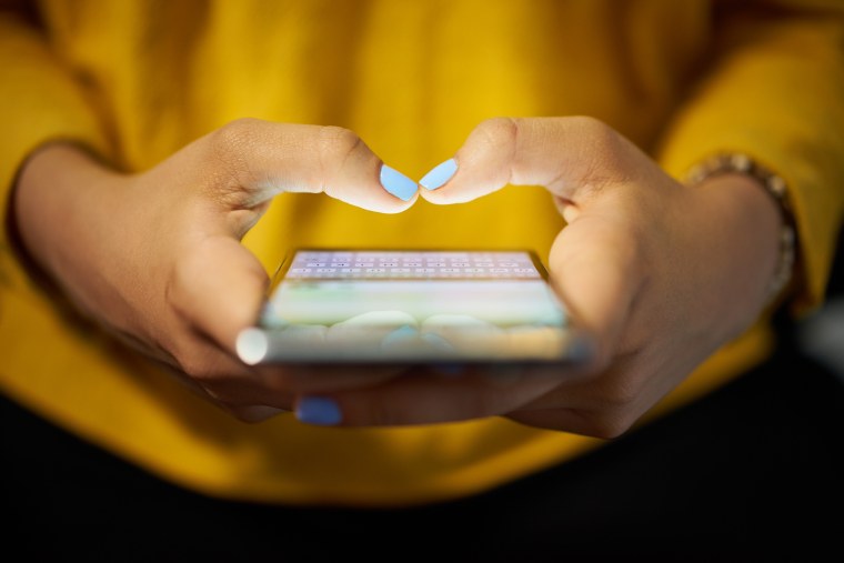 Image: Woman Typing Phone Message On Social Network At Night