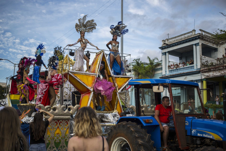 Image: Dancers and drag queens perform on a float pulled by a tractor during the annual LGBT pride parade