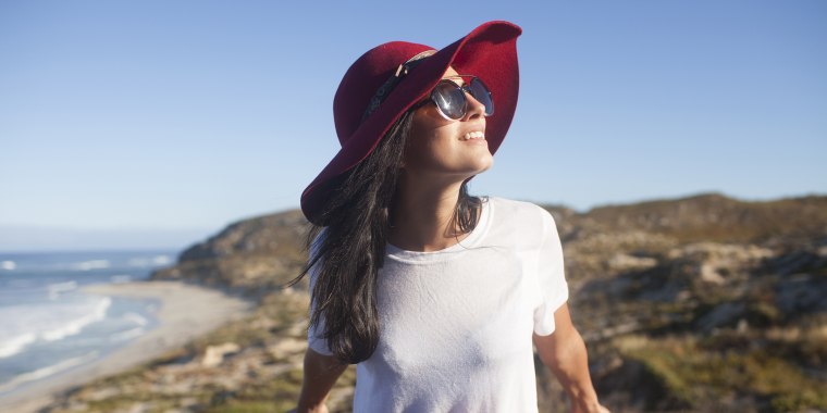 Young woman in sunhat at beach lookout Australia