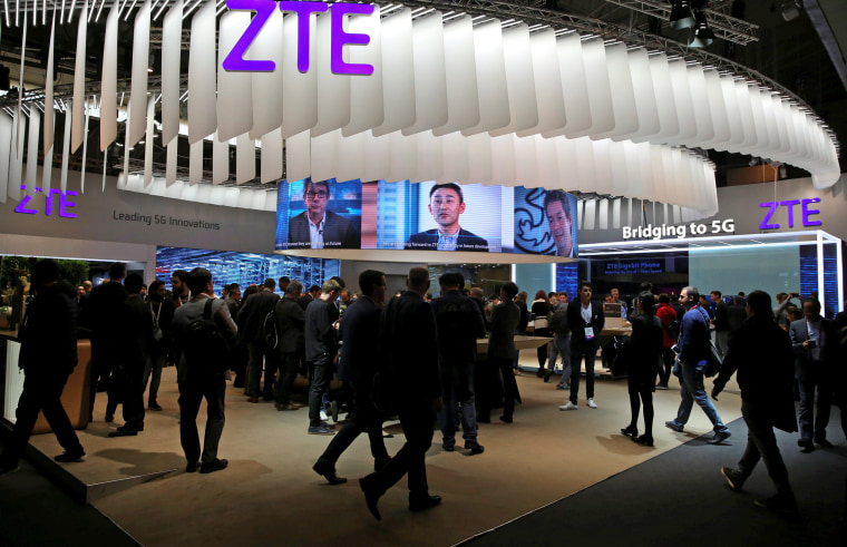 Image: FILE PHOTO: People stand at ZTE's booth during Mobile World Congress in Barcelona