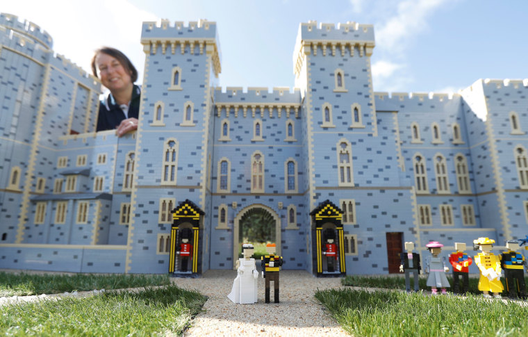 Image: Head model maker, Paula Laughton poses for a photograph with a LEGO Windsor Castle replete with royal wedding between Britain's Prince Harry and Meghan Markle, in Windsor