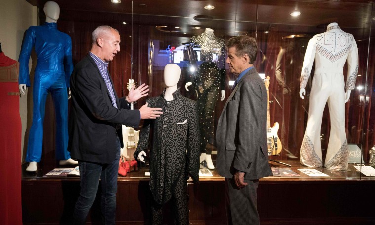 Image: Martin Nolan, executive director of Julien's Auctions, speaks with a reporter about Prince's Under the Cherry Moon ensemble