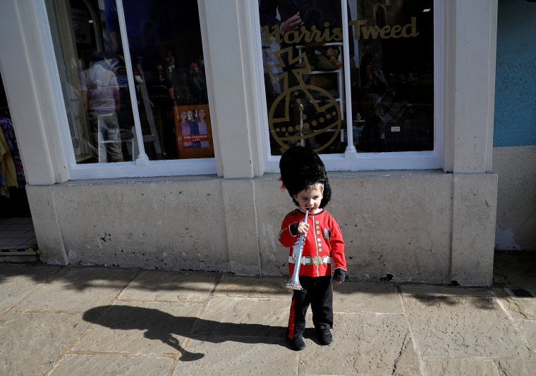 Image: Alex Tonkin, 2, wears a replica Guardsman's uniform as he plays with his trumpet ahead of Prince Harry and Meghan Markle's wedding, in Windsor