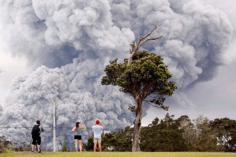 Image: People watch as ash erupt from the Halemaumau crater near the community of Volcano
