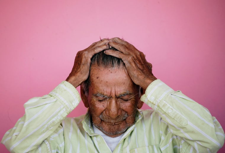 Image: Manuel Garcia, who says he is 121-years old, fixes his hair before posing for a photograph, outside his home in Ciudad Juarez