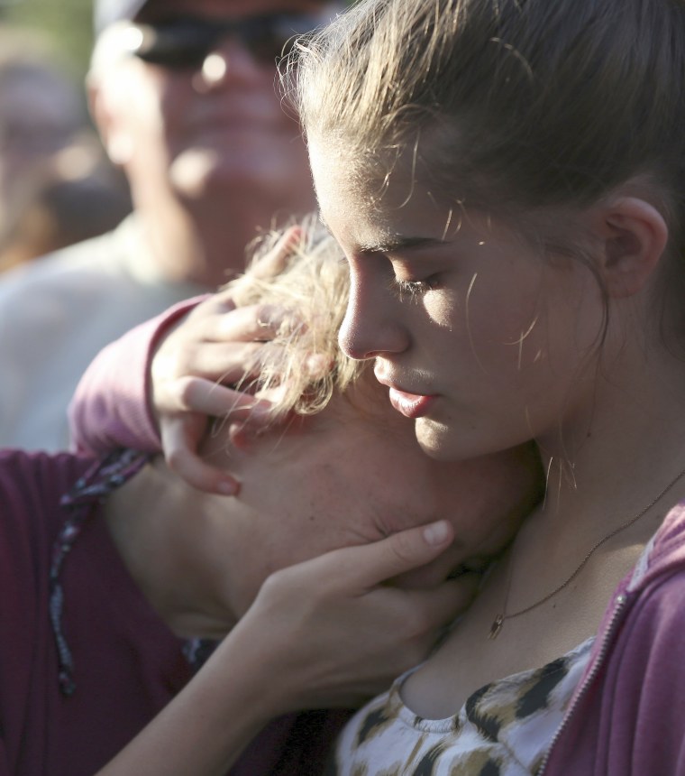 Image: Abigail Adams, right, comforts her friend Hannah Hershey, 13, during a vigil for the victims of the Santa Fe High School shooting, May 18, 2018, in Santa Fe, Texas.