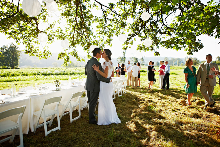 Bride and groom kissing outside