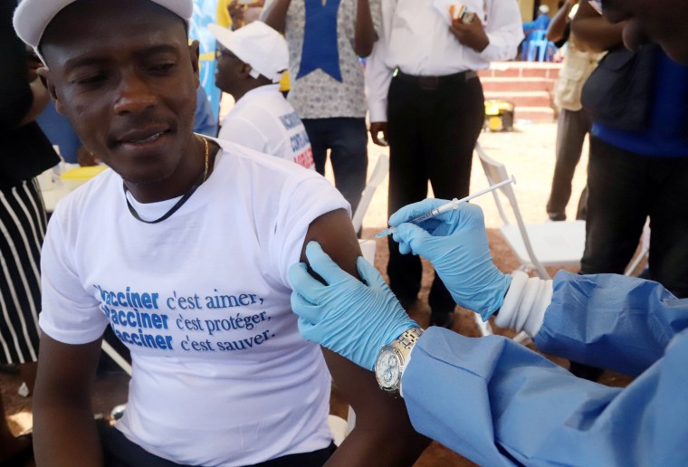 Image: A World Health Organization worker administers a vaccination during the launch of a campaign aimed at beating an outbreak of Ebola in the port city of Mbandaka