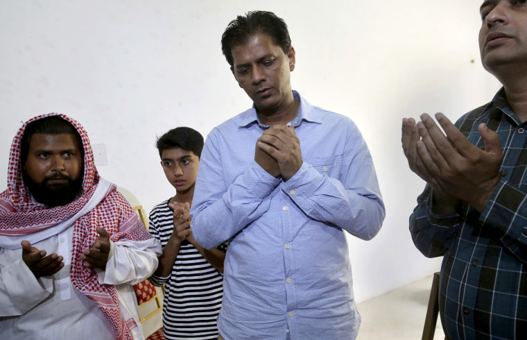 Image: Abdul Aziz Sheikh, center, father of Sabika Sheikh