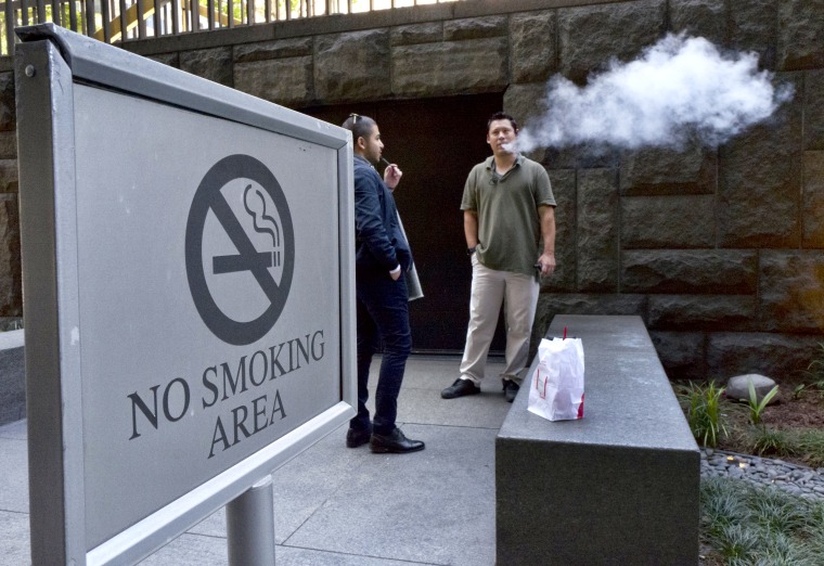 Image: Office workers take a vaping break in downtown Los Angeles on May 3, 2018.