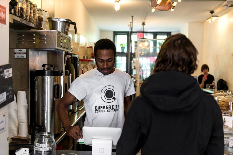 Image: Jayson McCoy, a barista at Quaker City Coffee, tends to a customer in Philadelphia on May 22, 2018.