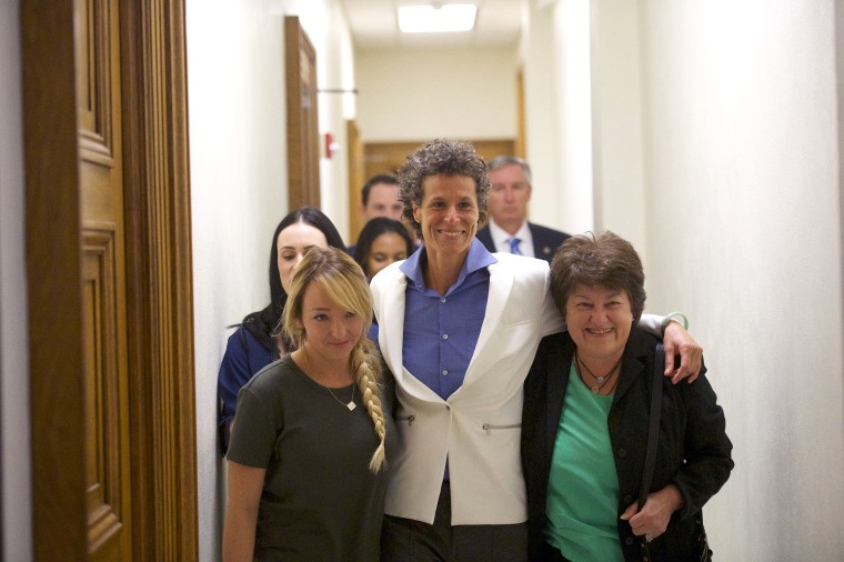 Image: Andrea Constand leaves court after a guilty verdict was delivered in Cosby's trial