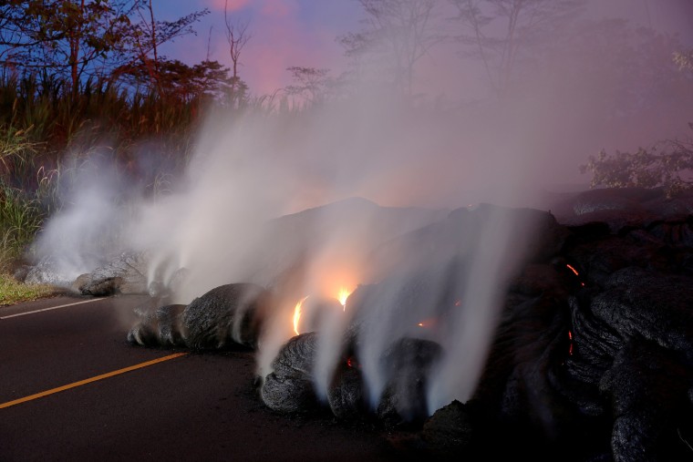 Image: Volcanic gases rise from the Kilauea lava flow that crossed Pohoiki Road near Highway 132, near Pahoa, Hawaii