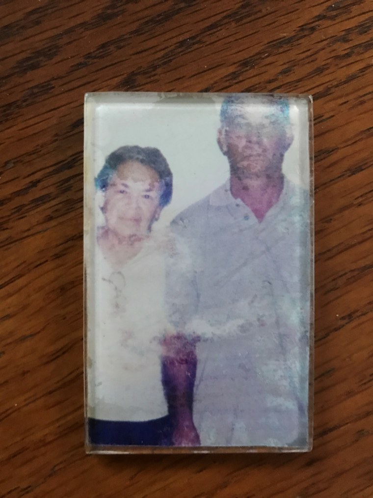 A photo with water damage of Pedro Lozada and his late wife, Consuelo Moran. This is one of the few things he has left of her.