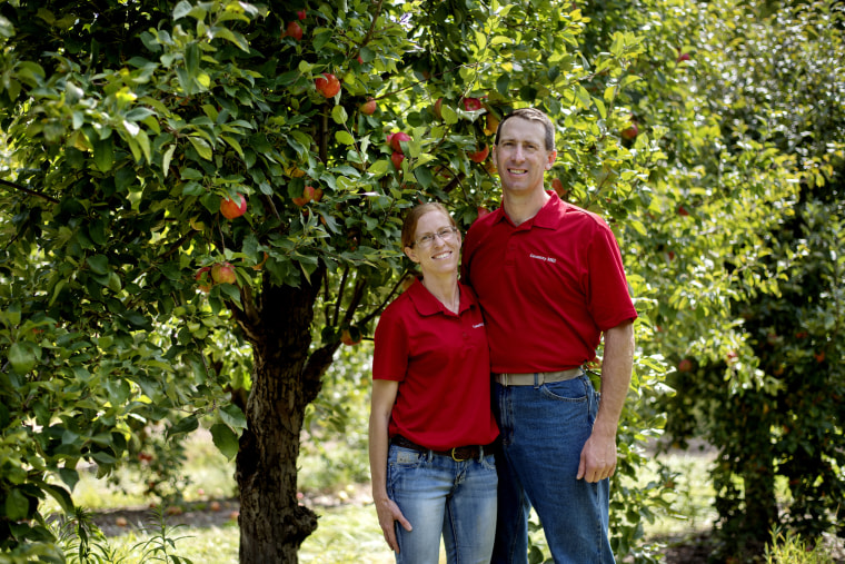 Image: Country Mill Farms owner Steve Tennes, left, and his wife Bridget are photographed in their orchard on Sept. 13, 2017, in Charlotte, Michigan.