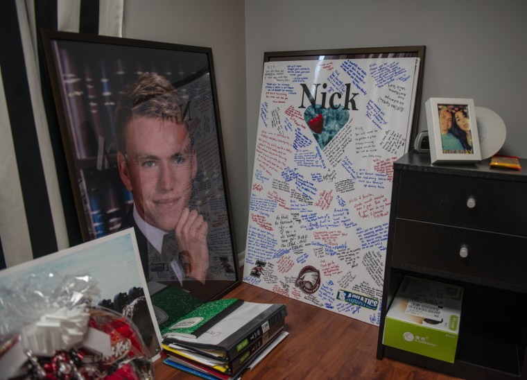 Image: A picture and a signed poster from his memorial sit in the room of Nick Dworet at his home in Coral Springs