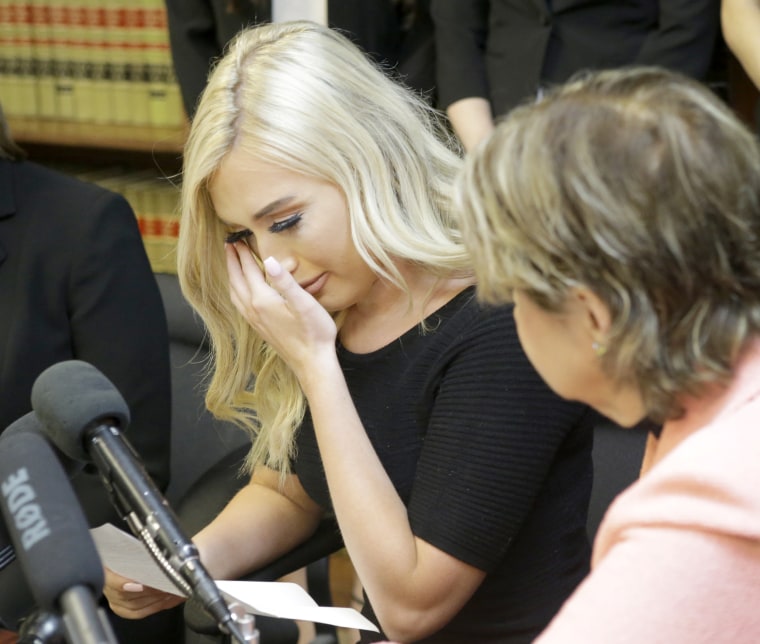 Image: Former Houston Texans cheerleader Hannah Turnbow wipes her tears as she speaks sitting beside attorney Gloria Allred during a press conference, on June 1, 2018, in Humble, Texas, announcing a lawsuit on behalf of five former NFL cheerleaders.