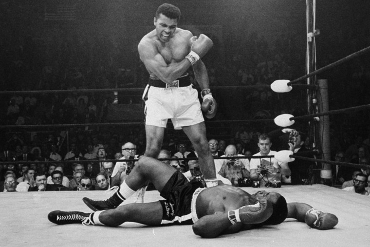 Image: Heavyweight champion Muhammad Ali stands over fallen challenger Sonny Liston, shouting and gesturing shortly after dropping Liston with a short hard right to the jaw on May 25, 1965, in Lewiston, Maine.