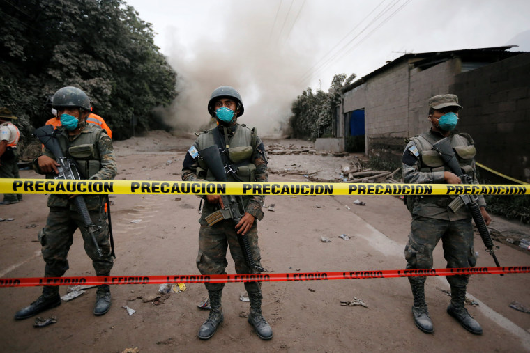 Image: Soldiers keep watch at a restricted area affected by an eruption from Fuego volcano in the community of San Miguel Los Lotes in Escuintla