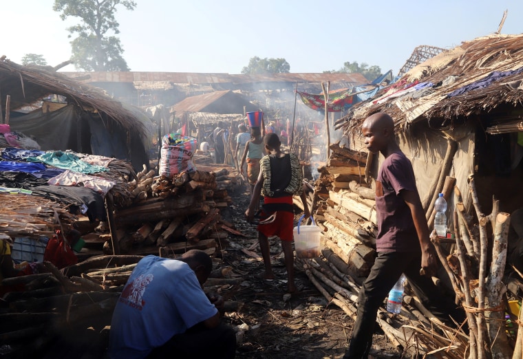 Image: Traders walk at an open air market