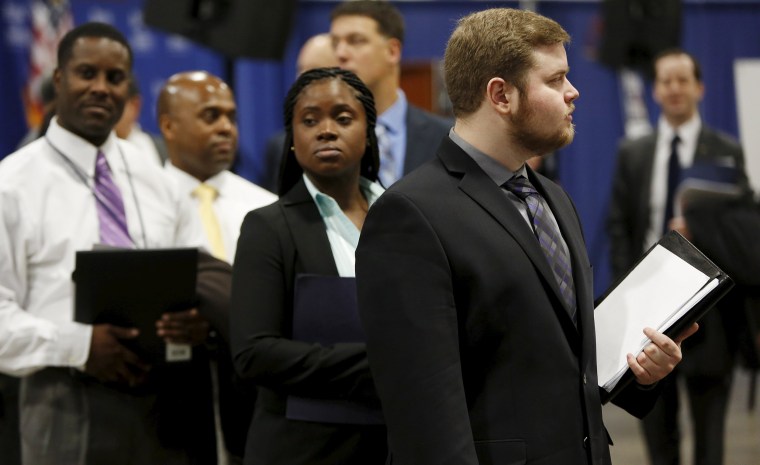 Image: Job applicants await their turn at the Lockheed Martin booth at \"Hiring Our Heroes\" military job fair in Washington