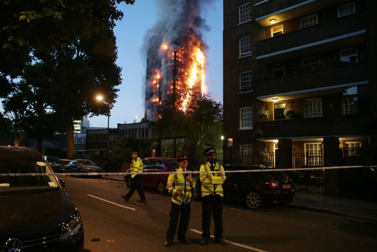 Image: Police maintain a security cordon as a huge fire engulfs the Grenfell Tower 