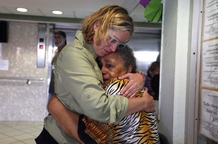 Image: San Juan's Mayor Carmen Yulin Cruz, left, hugs a woman during her visit to a nursing home in San Juan