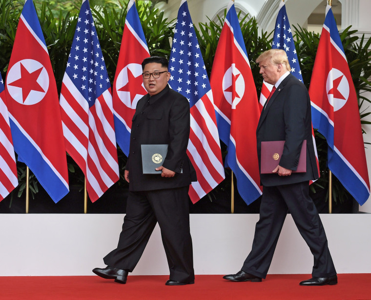 Image: U.S. President Donald Trump and North Korea's leader Kim Jong Un react during their summit at the Capella Hotel on Sentosa island in Singapore