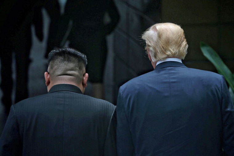 Image: U.S. President Donald Trump walks with North Korean leader Kim Jong Un at the Capella Hotel on Sentosa island in Singapore