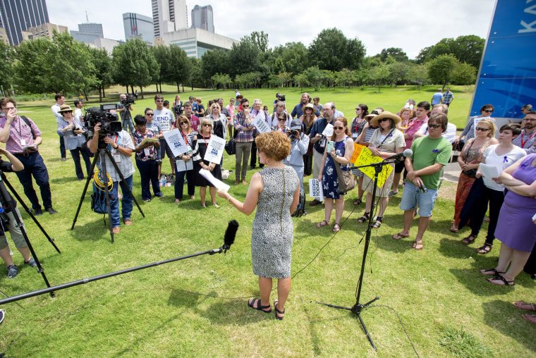 Image: Carolyn Deevers speaks about her former marriage to an abusive pastor during a rally protesting the Southern Baptist Convention's treatment of women