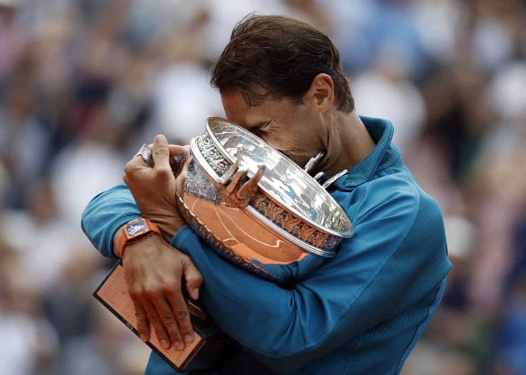 Image: Rafael Nadal of Spain celebrates with the trophy after winning the French Open championship