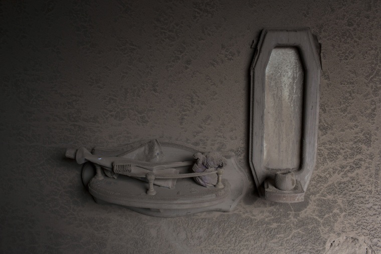 Image: A toothbrush and toothpaste are coated in volcanic ash in San Miguel Los Lotes, Guatemala
