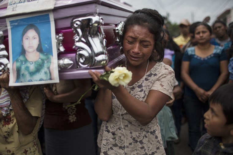 Image: Yoselin Rancho cries as she carries the remains of her best friend, Etelvina Charal, who died from the eruption of the Volcano of Fire