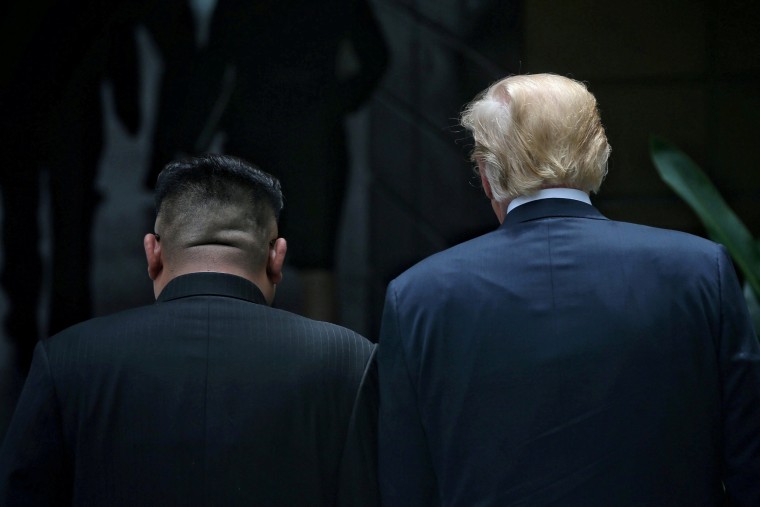 Image: President Donald Trump walks with North Korean leader Kim Jong Un at the Capella Hotel on Sentosa island in Singapore