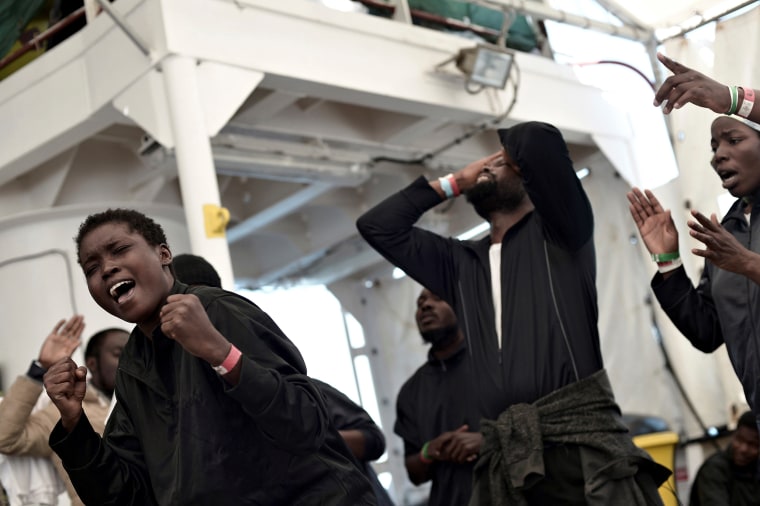Image: Migrants rejoice before disembarking the rescue ship Aquarius in Valencia