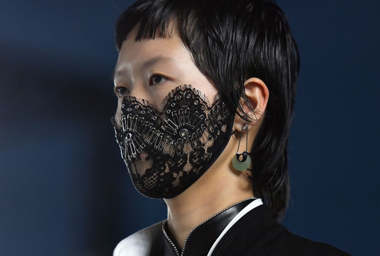 Image: A model wears a decorated surgical mask