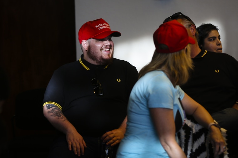 Image: A proud man waits to hear Candace Owens speak