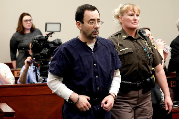 Image: Larry Nassar, a former team USA Gymnastics doctor, who pleaded guilty in November 2017 to sexual assault charges, is led from the courtroom after listening to victim testimony during his sentencing hearing in Lansing, Michigan