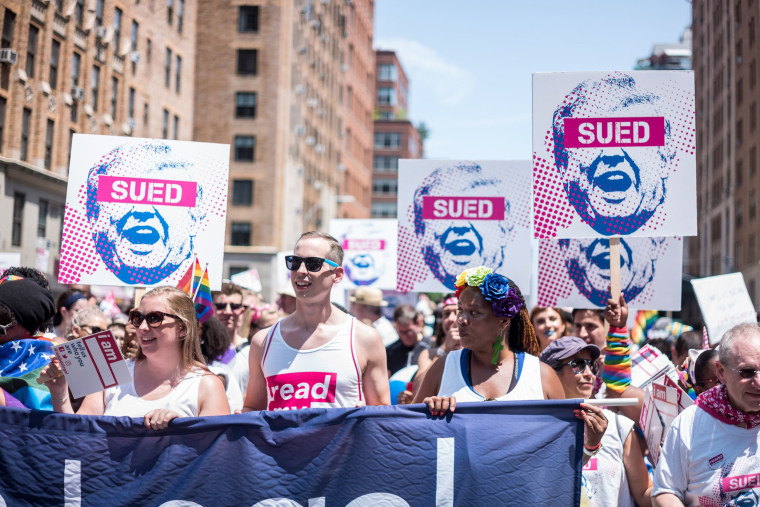 Image: Participants carry signs during the Pride parade in New York