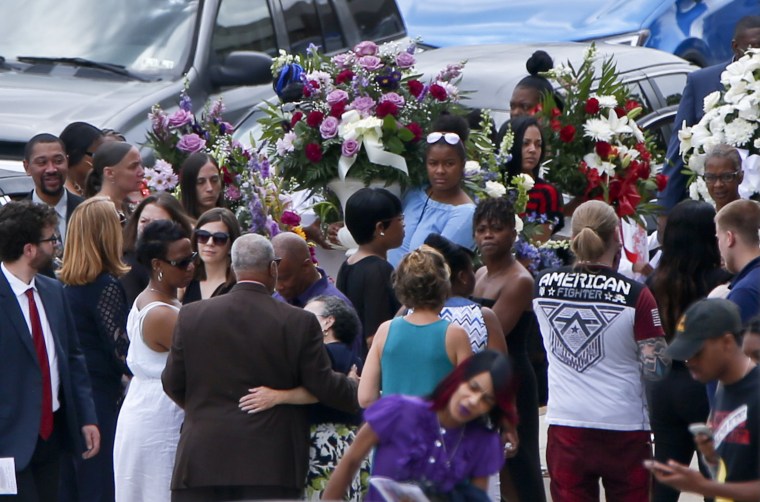 Image: People carry flowers as they leave Antwon Rose Jr.'s funeral