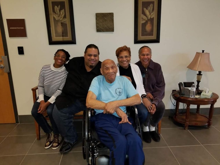 Kenneth Bowser (center) visits with (from left) grandchildren Tonya Cotton and Mark Cotton and daughters Sharon Van Leer and Janet Bowser at a locked forensic nursing home in St. Peter, Minnesota