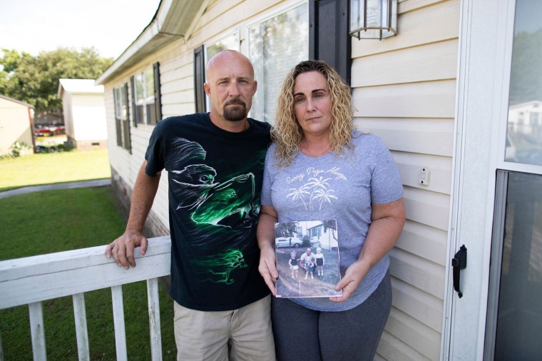 Allen Holtzman and his fianc?e, Christal Collins, stand outside their home in Conway, South Carolina, on June 4, 2018.