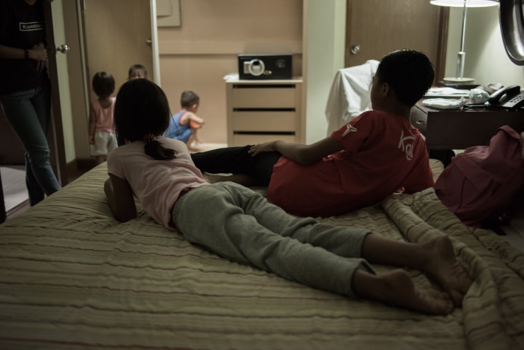 Image: The children rescued from the raid rest in a room before being brought to a shelter