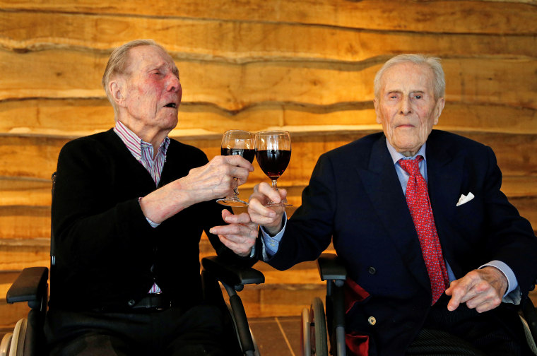 The world's oldest living twin brothers, Paulus and Pieter Langerock from Belgium, 102, toast with a glass of red wine at the Ter Venne retirement home in Sint-Martens-Latem