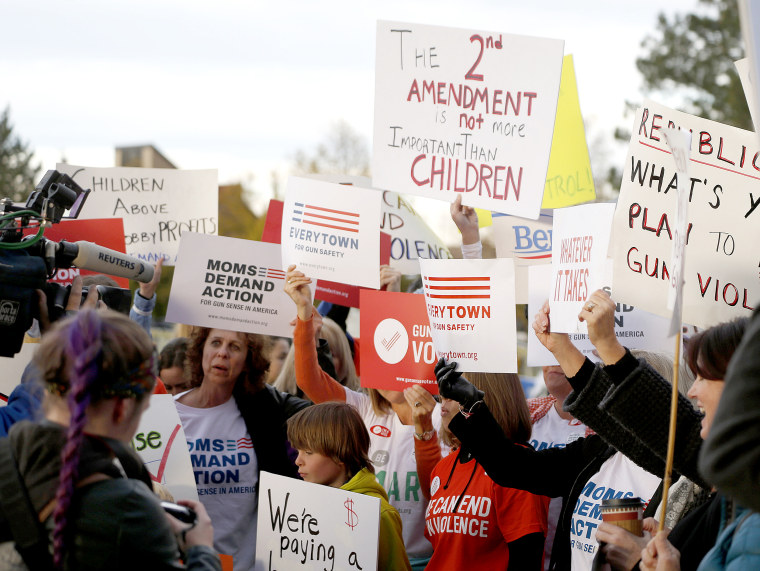 Image: Protesters hold up placards calling for gun laws