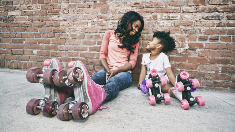 Mother and daughter wearing roller skates