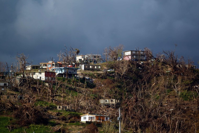 Image: Damaged houses are seen on top of a hill in Yabucoa, Puerto Rico