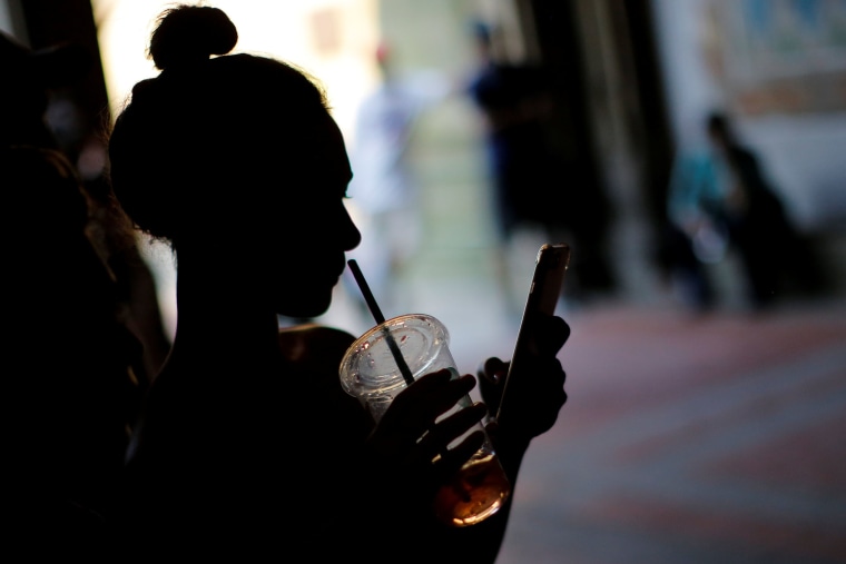 Image: A woman holds a drink 