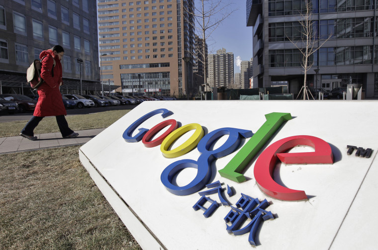 Image: A woman walks past the logo of Google in front of its headquarters in Beijing
