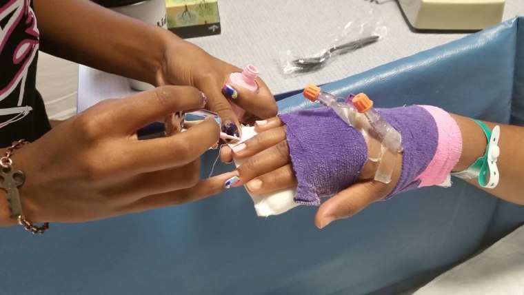 Alanna Wall polishes a child's nails in the hospital